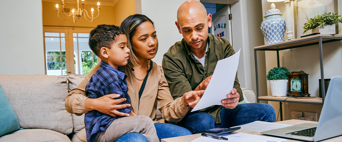 Family reading a document.